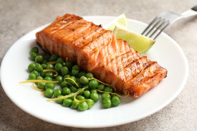 Photo of Delicious grilled salmon fillet served on grey table, closeup