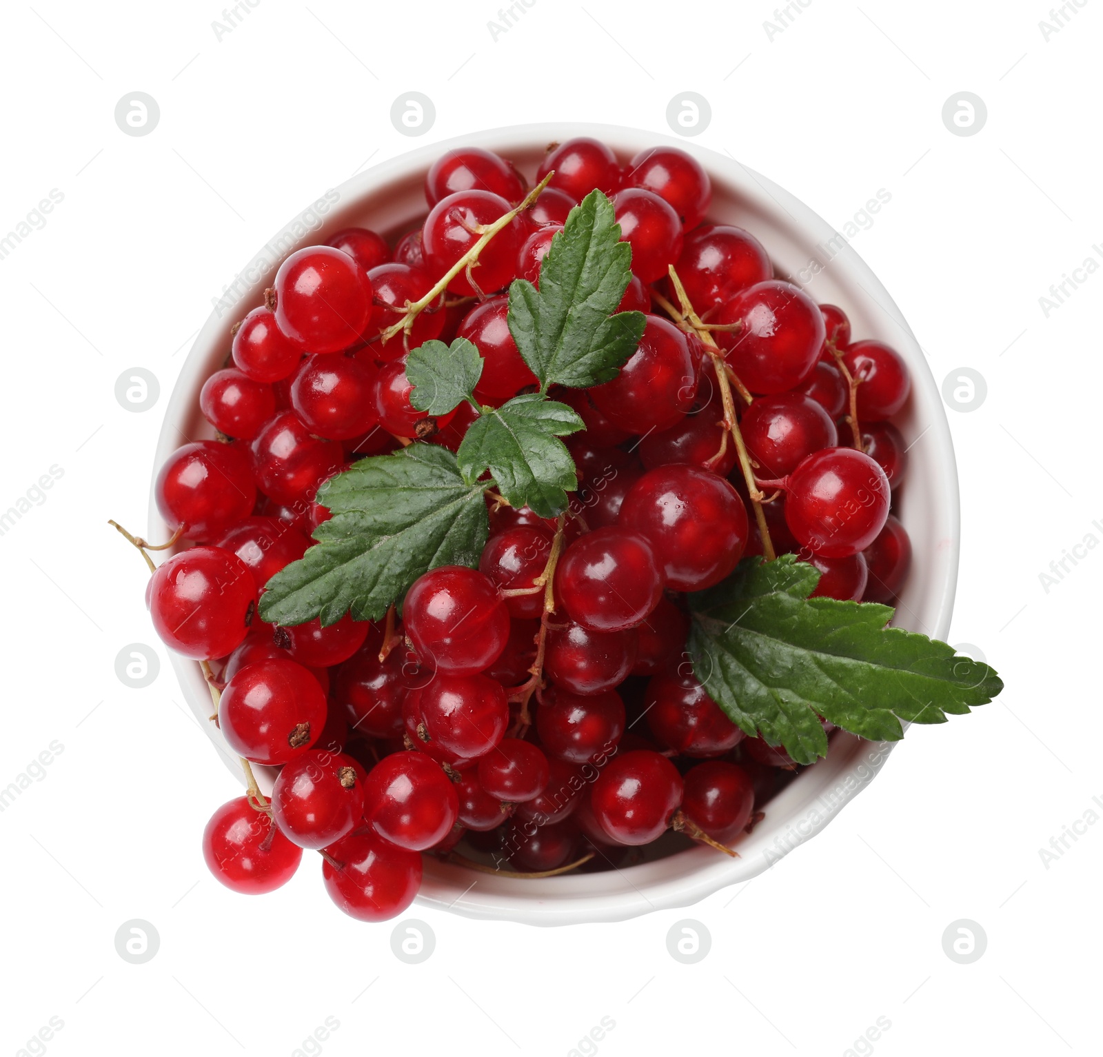 Photo of Ripe red currants with green leaves in bowl isolated on white, top view