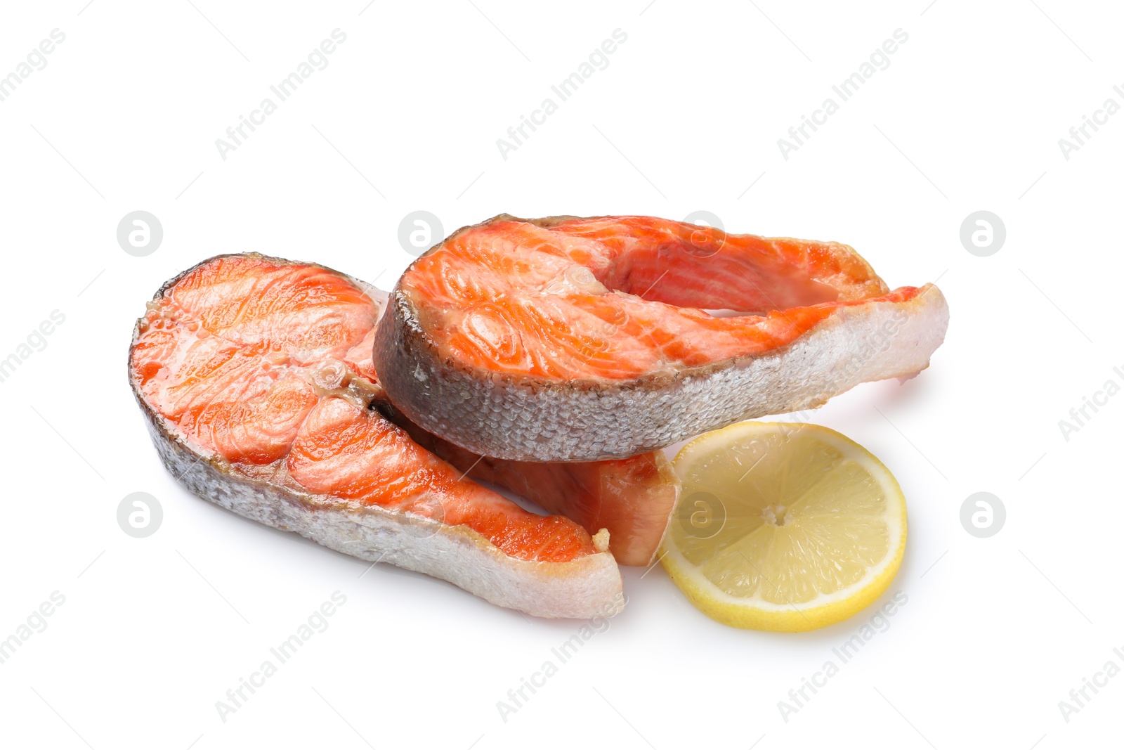 Photo of Tasty grilled salmon steaks and lemon isolated on white