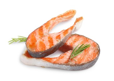 Photo of Tasty grilled salmon steaks and rosemary isolated on white