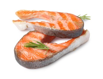 Photo of Tasty grilled salmon steaks and rosemary isolated on white