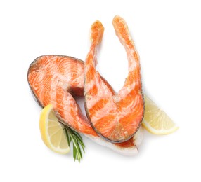 Photo of Tasty grilled salmon steaks, lemon and rosemary isolated on white, top view