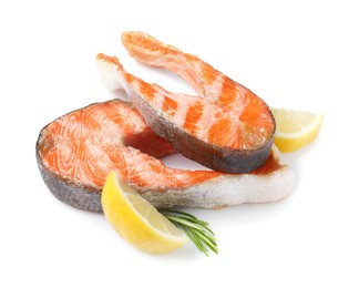 Photo of Tasty grilled salmon steaks, lemon and rosemary isolated on white