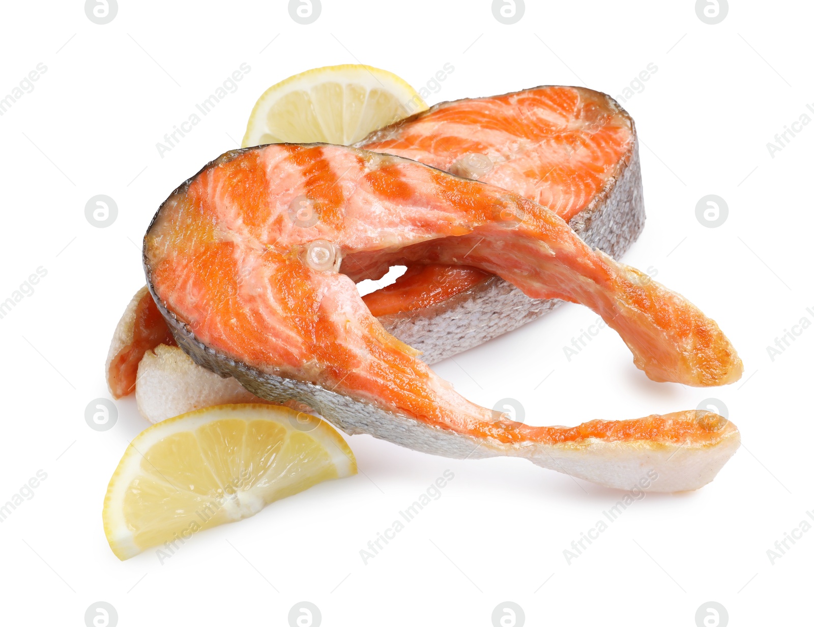 Photo of Tasty grilled salmon steaks and lemon isolated on white