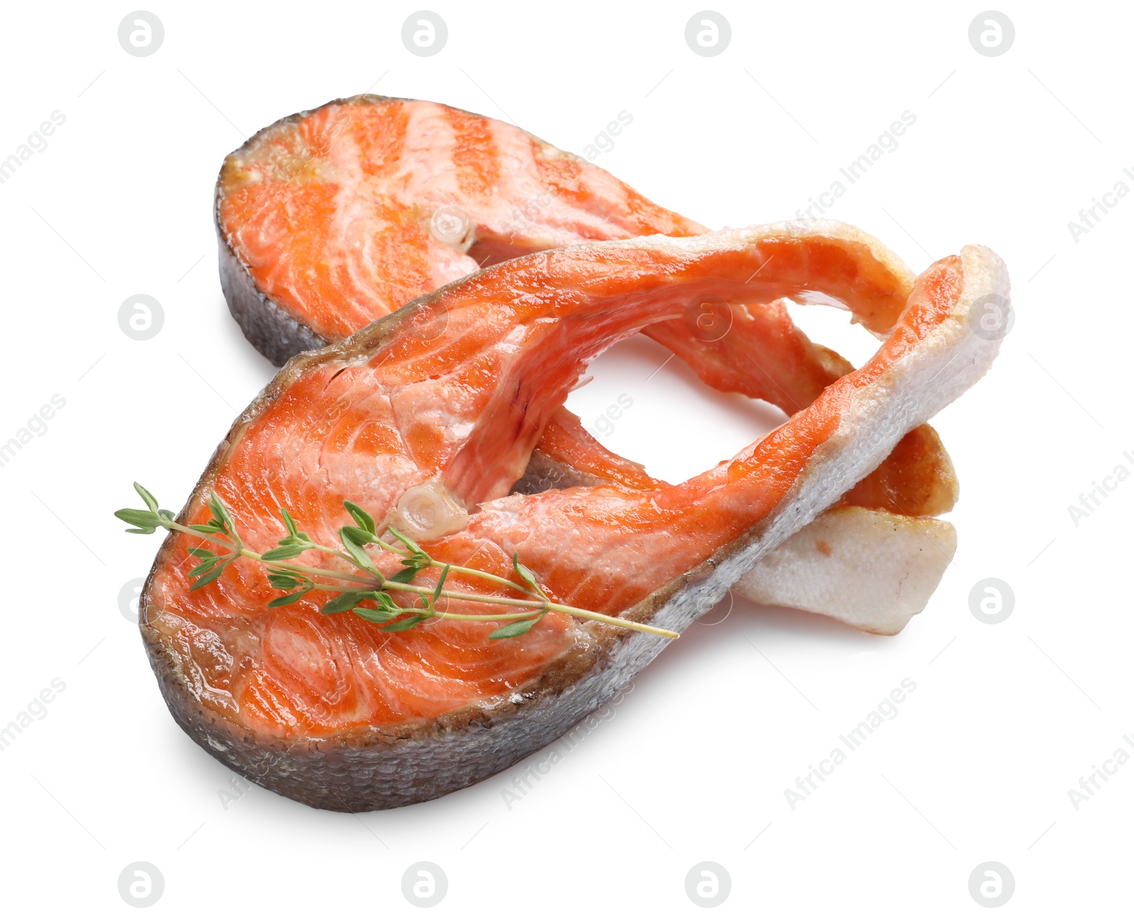 Photo of Tasty grilled salmon steaks and thyme isolated on white