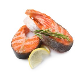 Photo of Tasty grilled salmon steaks and rosemary isolated on white