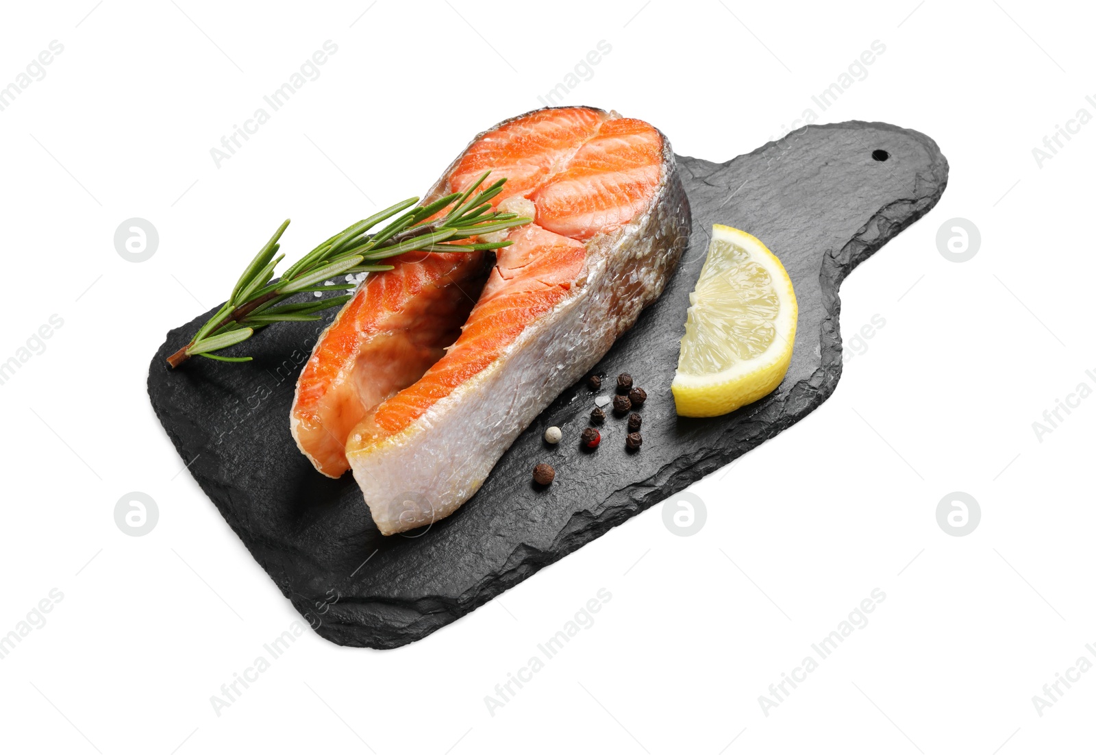 Photo of Tasty grilled salmon steak, lemon and spices isolated on white