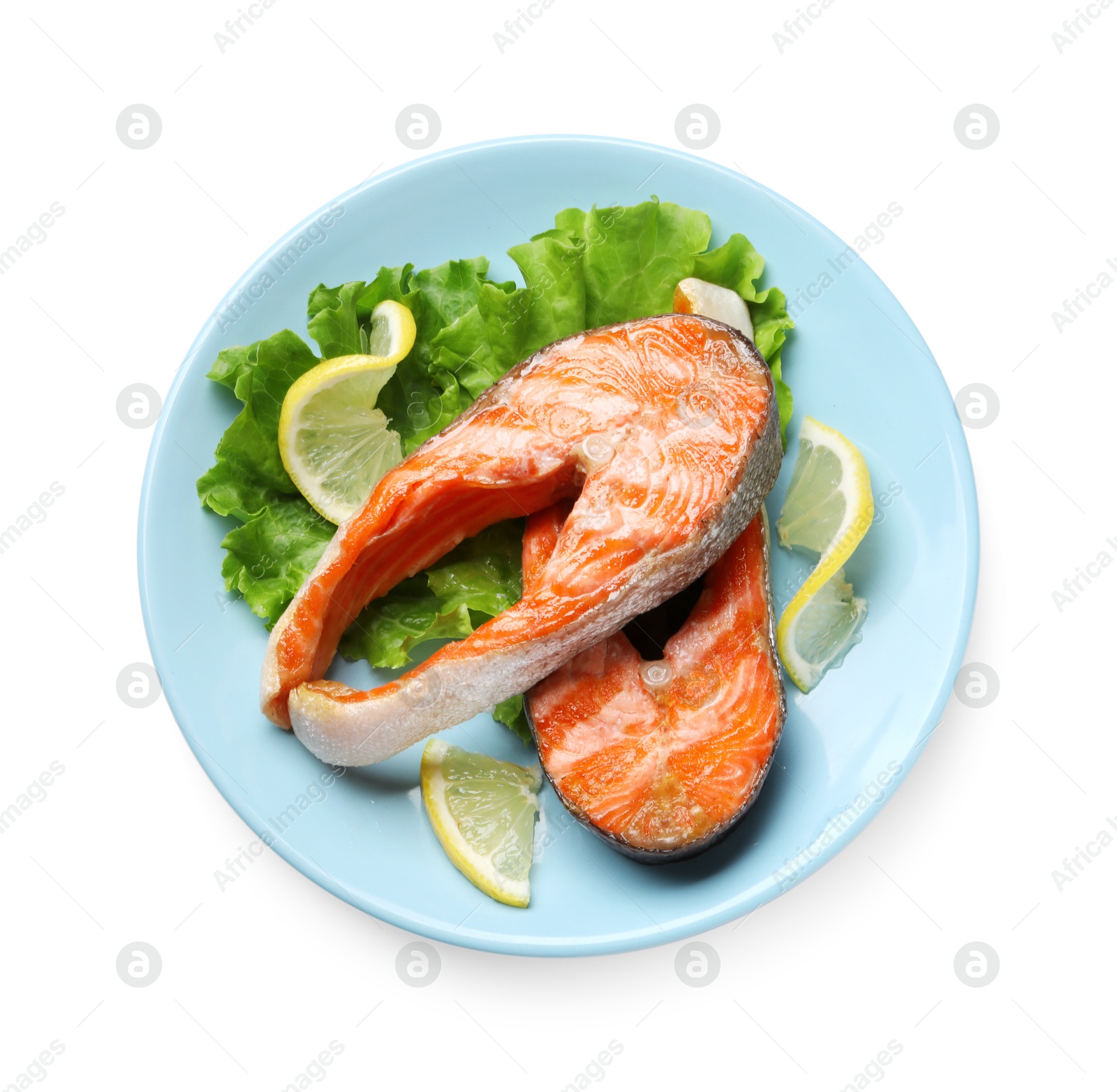 Photo of Tasty grilled salmon steaks, lettuce and lemon isolated on white, top view