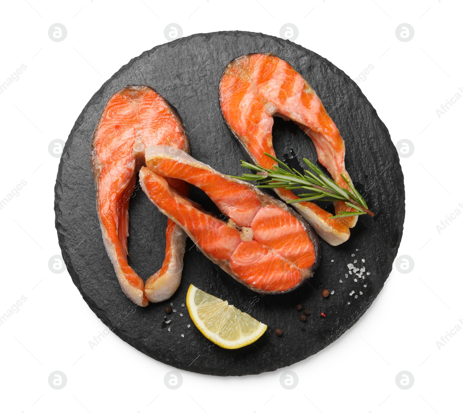 Photo of Tasty grilled salmon steaks, lemon and spices isolated on white, top view