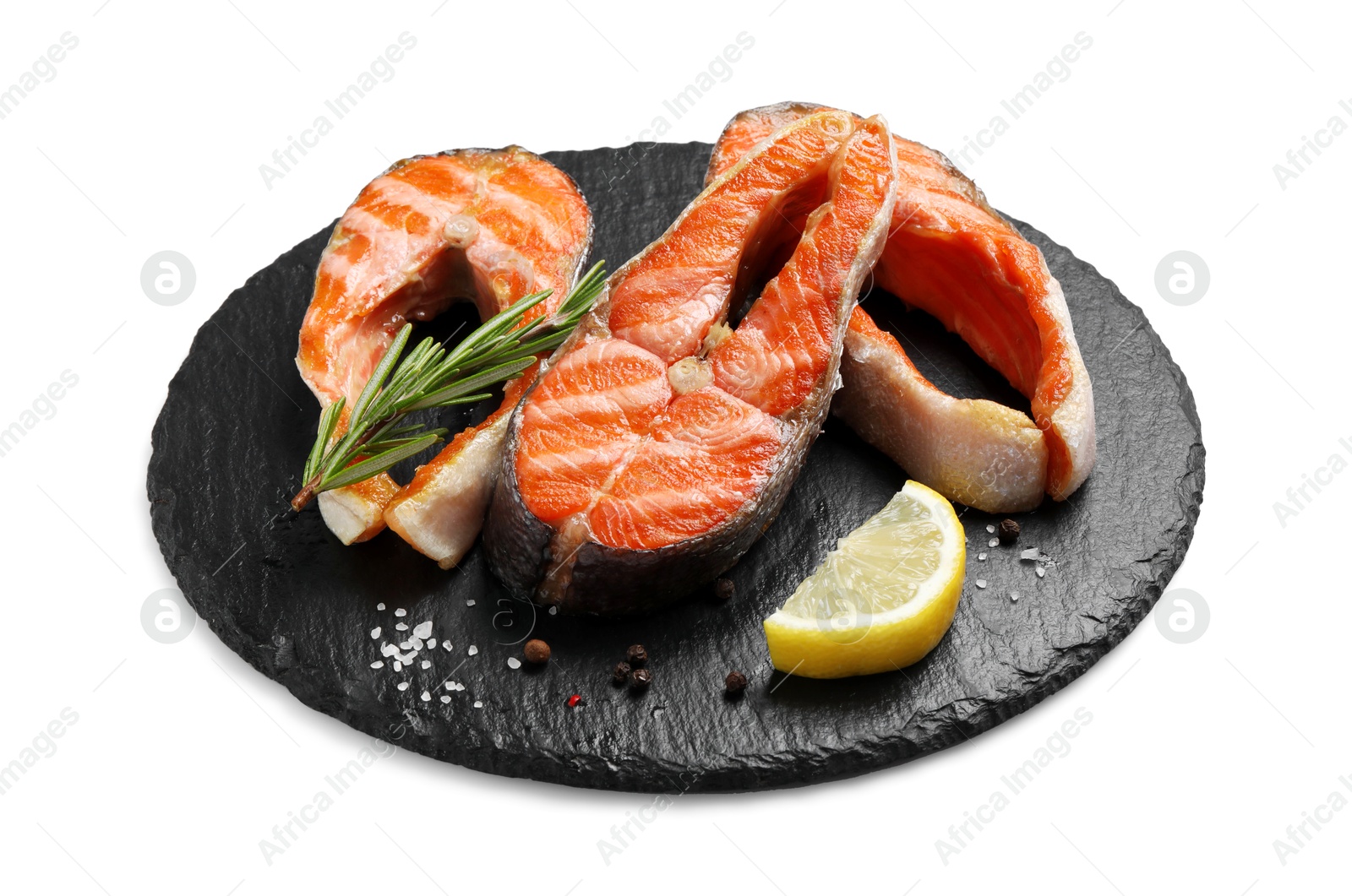 Photo of Tasty grilled salmon steaks, lemon and spices isolated on white