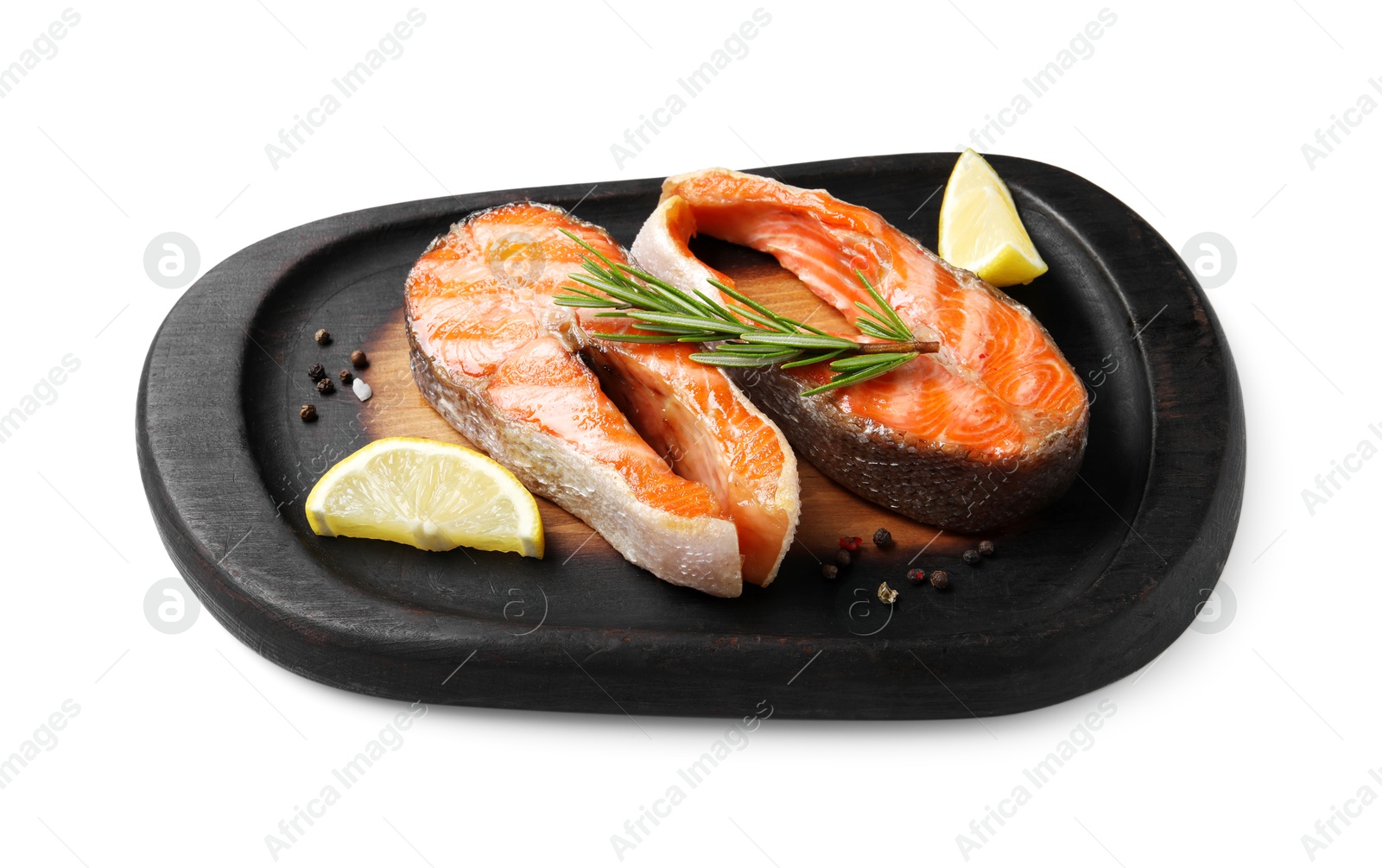 Photo of Tasty grilled salmon steaks, lemon and spices isolated on white