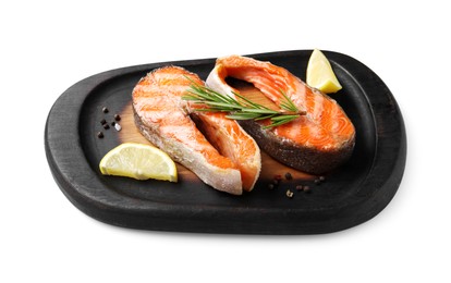 Photo of Tasty grilled salmon steaks, lemon and spices isolated on white