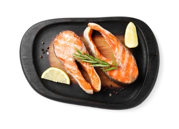 Photo of Tasty grilled salmon steaks, lemon and spices isolated on white, top view