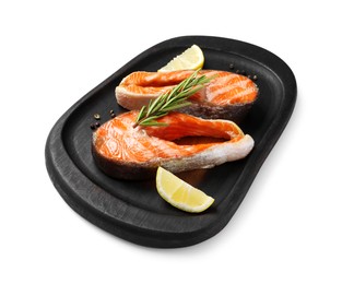 Photo of Tasty grilled salmon steaks, lemon and spices isolated on white