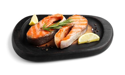 Photo of Tasty grilled salmon steaks, lemon and spices isolated on white