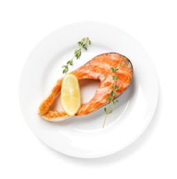 Photo of Tasty grilled salmon steak, lemon and thyme isolated on white, top view