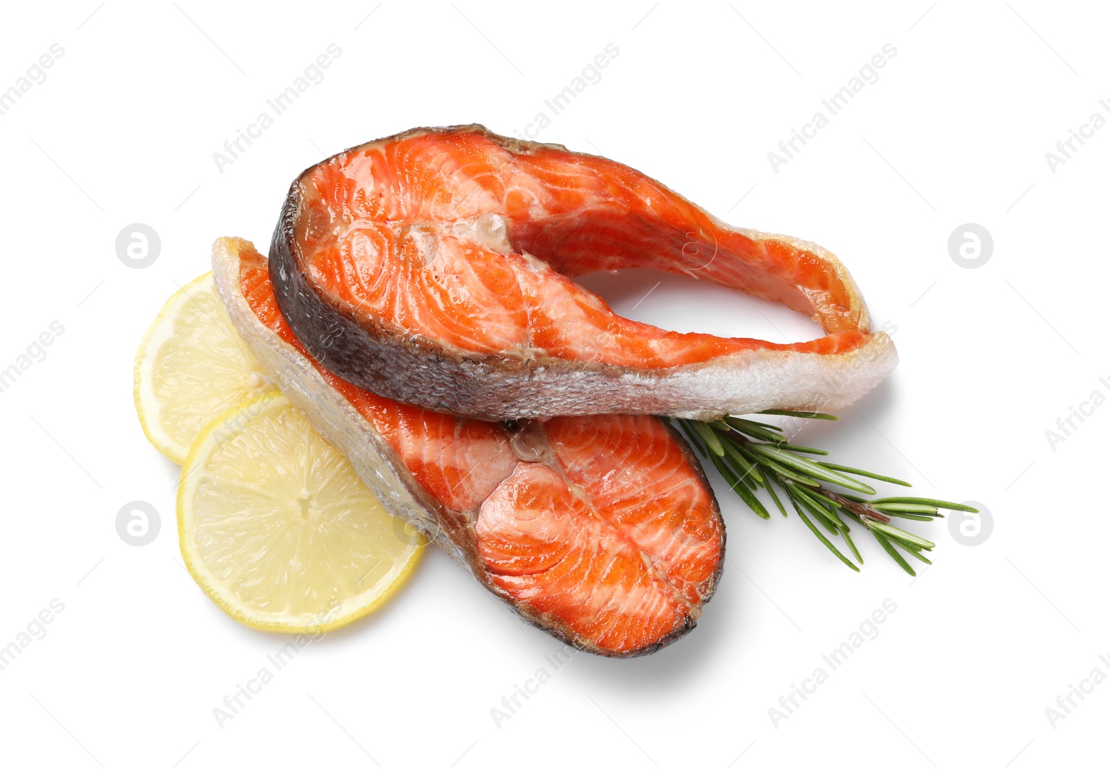 Photo of Tasty grilled salmon steaks, lemon and rosemary isolated on white, top view