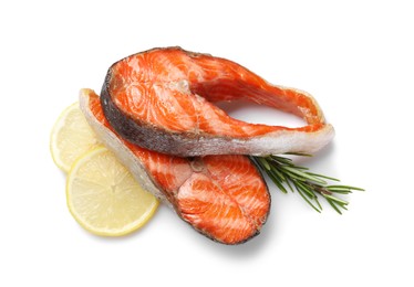 Photo of Tasty grilled salmon steaks, lemon and rosemary isolated on white, top view