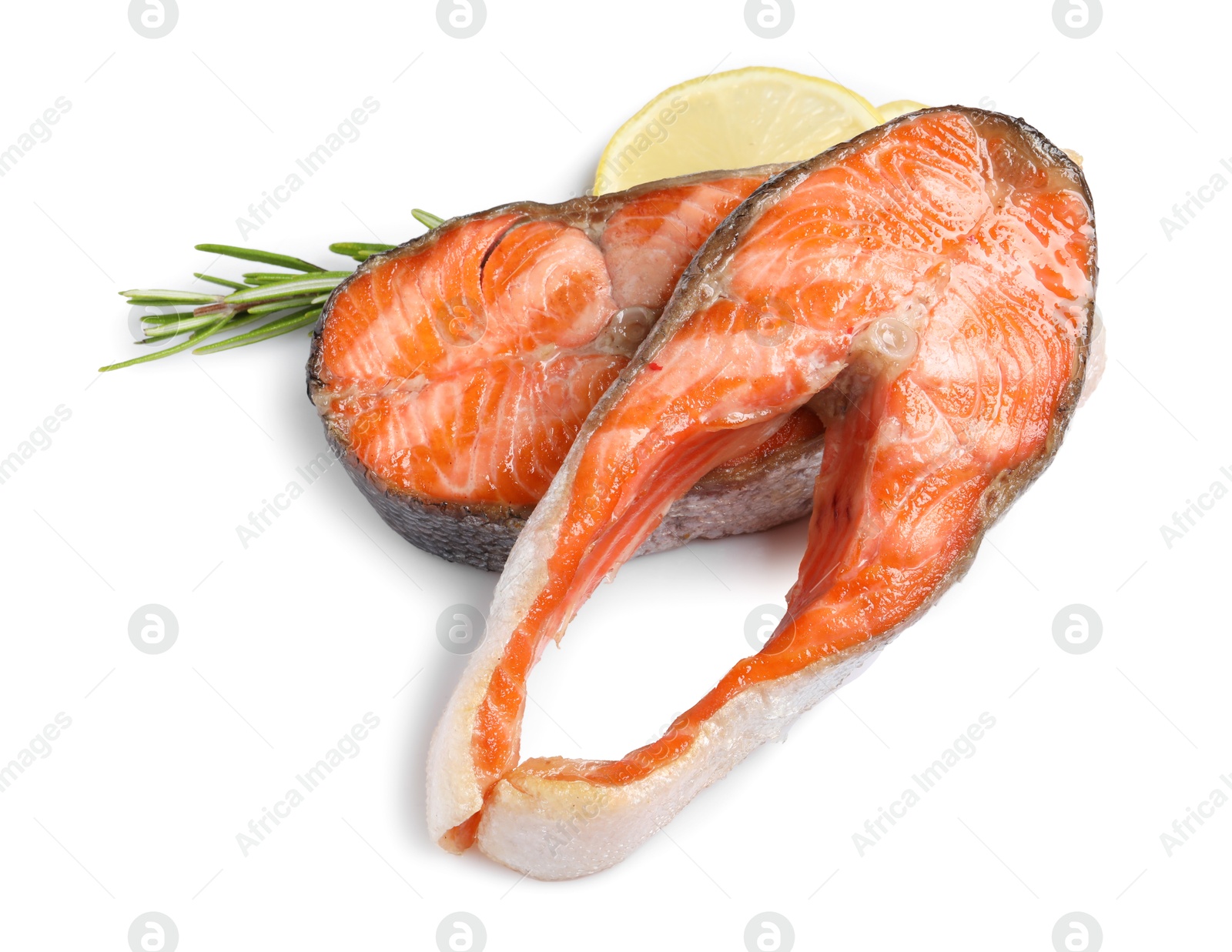 Photo of Tasty grilled salmon steaks, lemon and rosemary isolated on white, top view