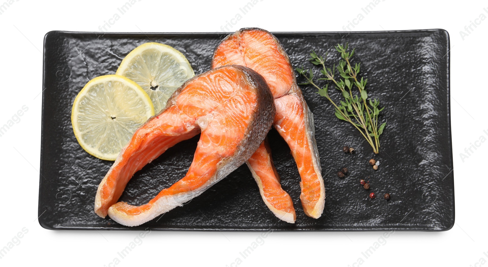 Photo of Tasty grilled salmon steaks, lemon and spices isolated on white, top view