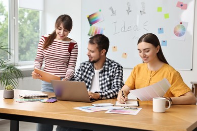 Photo of Group of designers working together in office