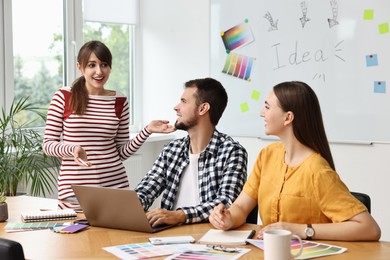 Photo of Group of designers working together in office