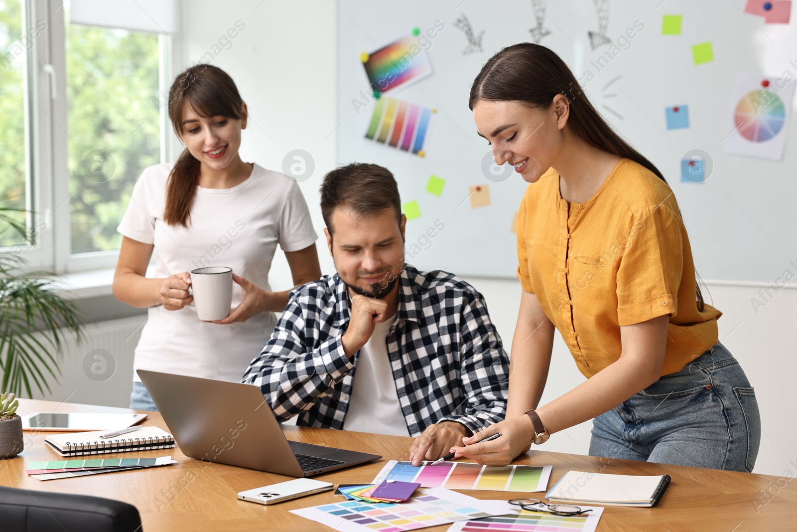 Photo of Group of designers working together in office