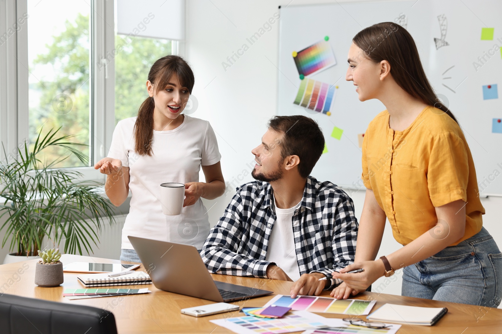 Photo of Group of designers working together in office