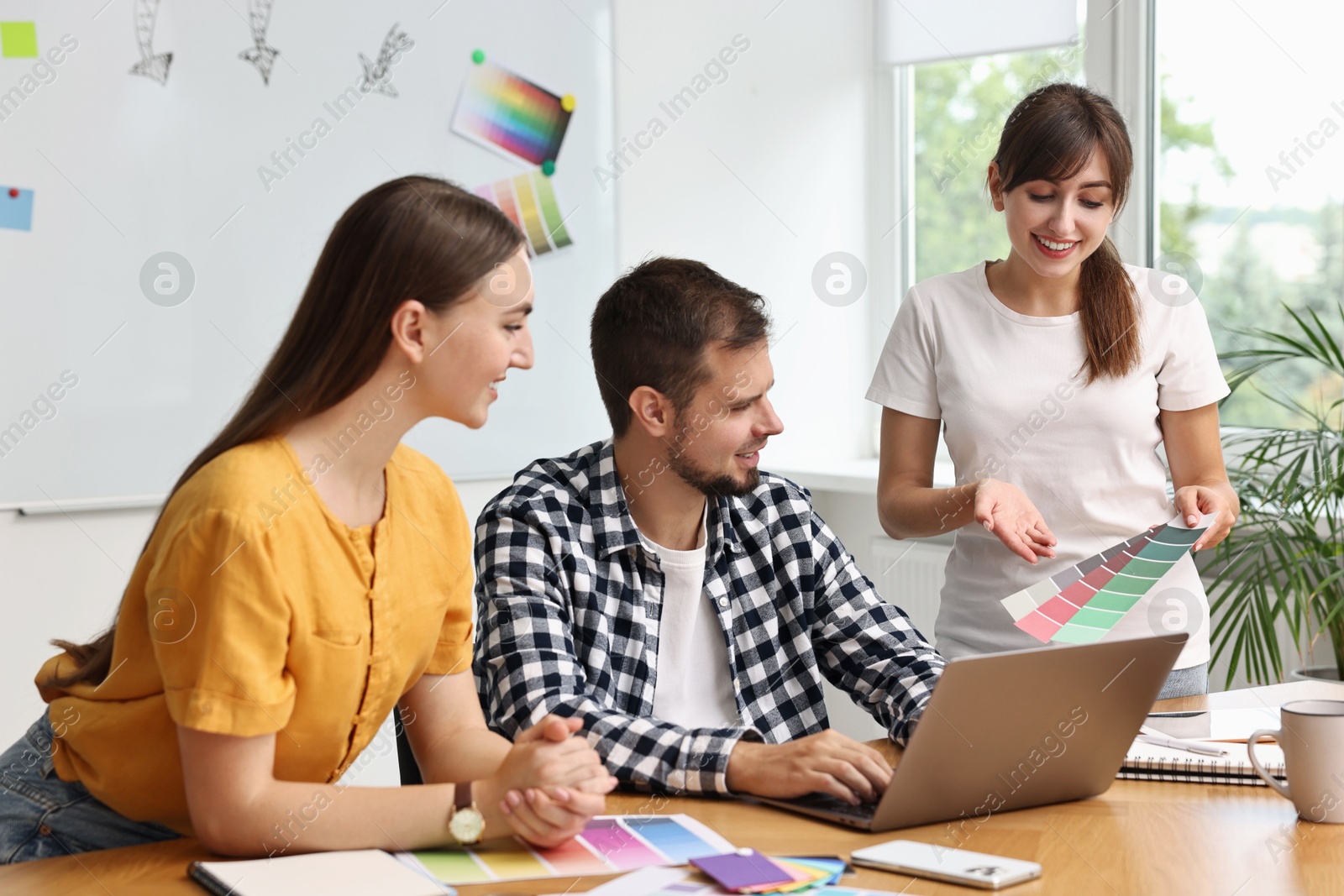 Photo of Group of designers working together in office