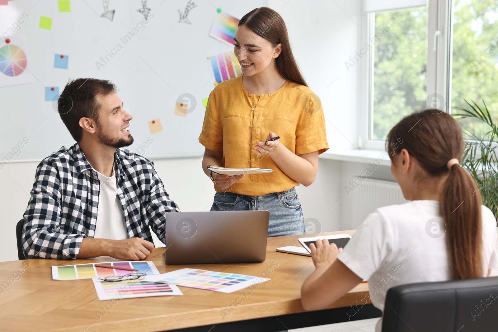 Photo of Group of designers working together in office