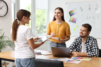 Photo of Group of designers working together in office