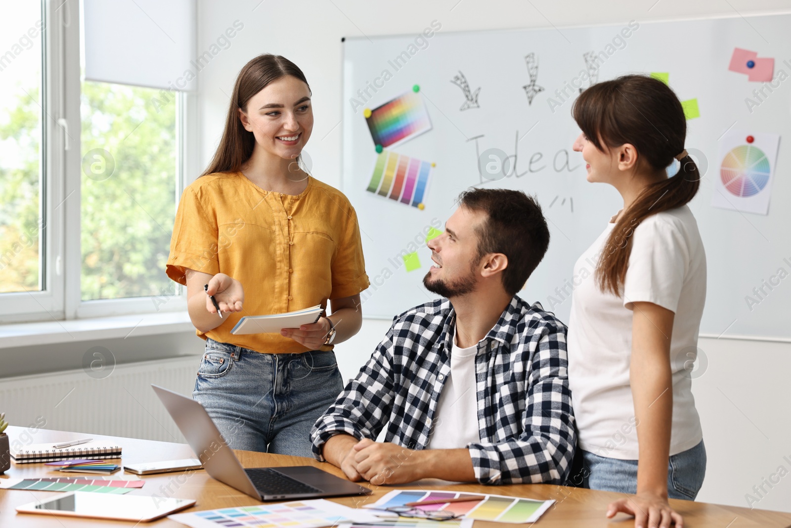 Photo of Group of designers working together in office