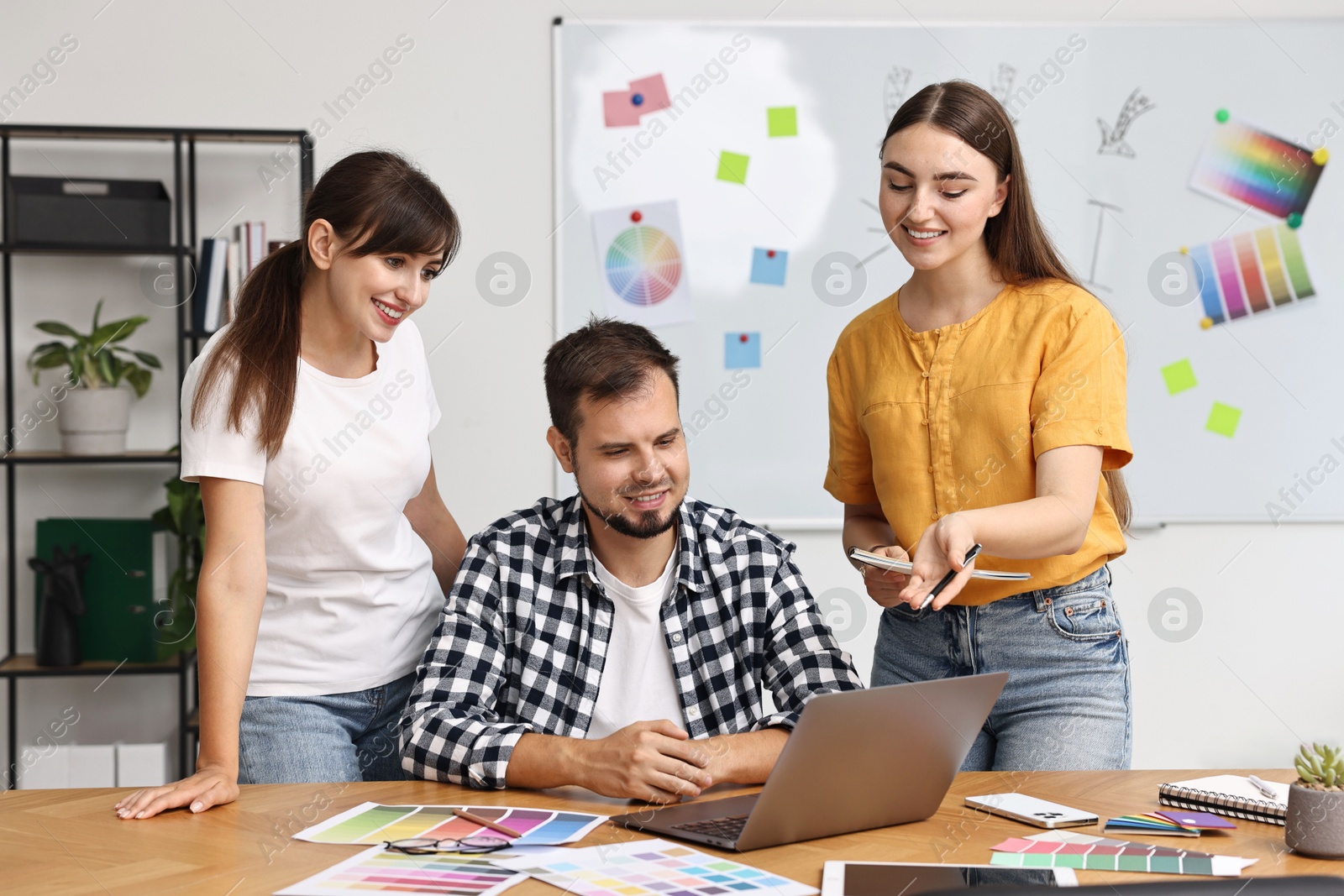 Photo of Group of designers working together in office