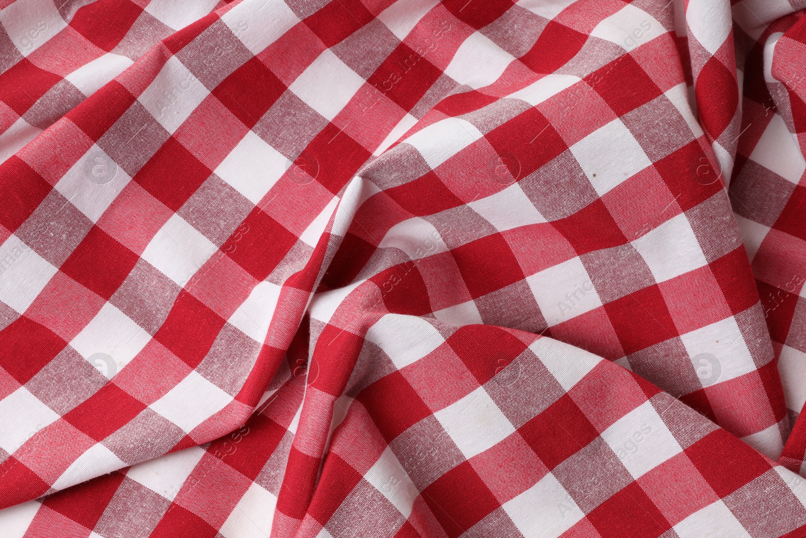 Photo of Crumpled checkered tablecloth as background, top view