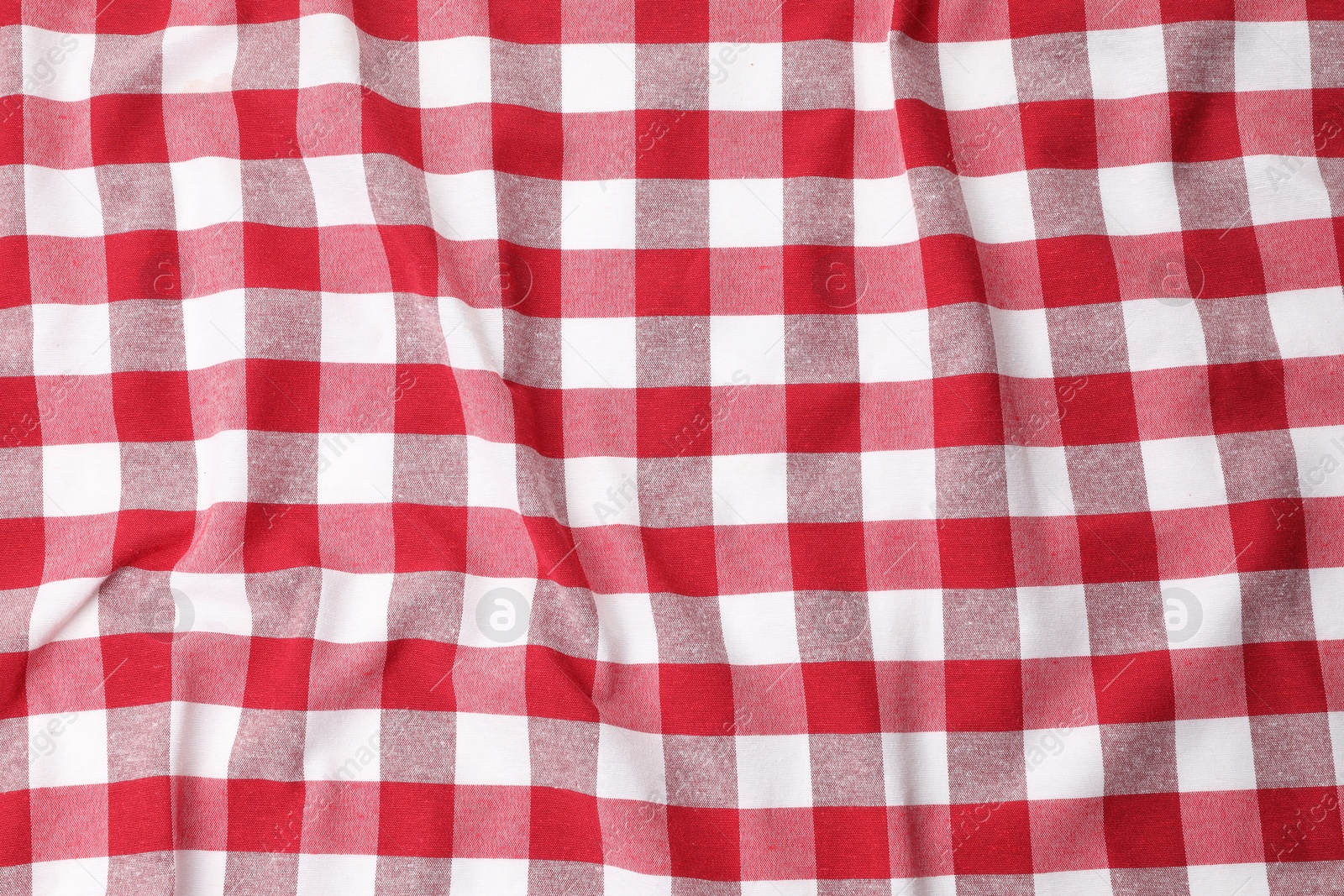 Photo of Crumpled checkered tablecloth as background, top view