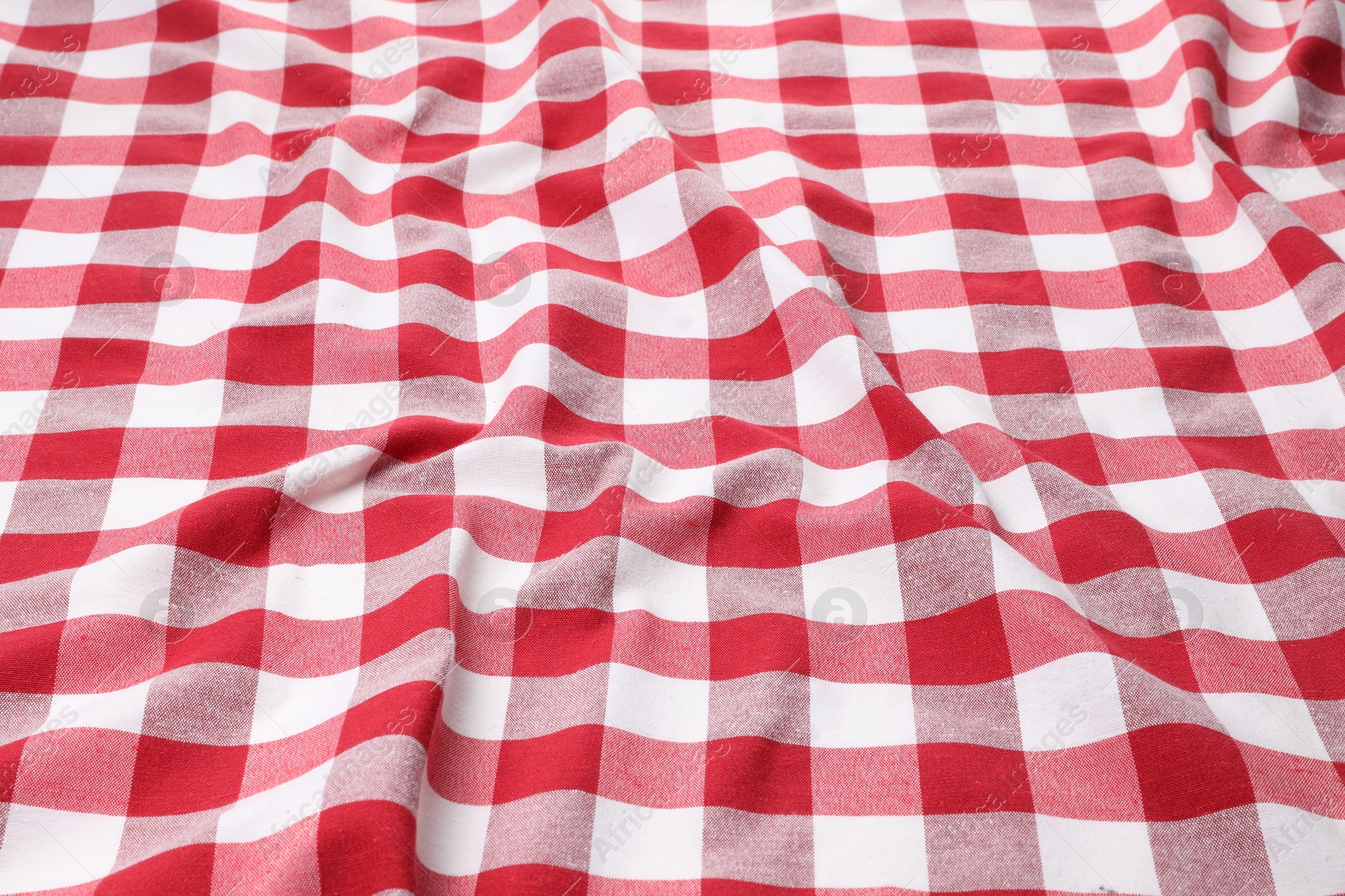 Photo of Crumpled checkered tablecloth as background, closeup view