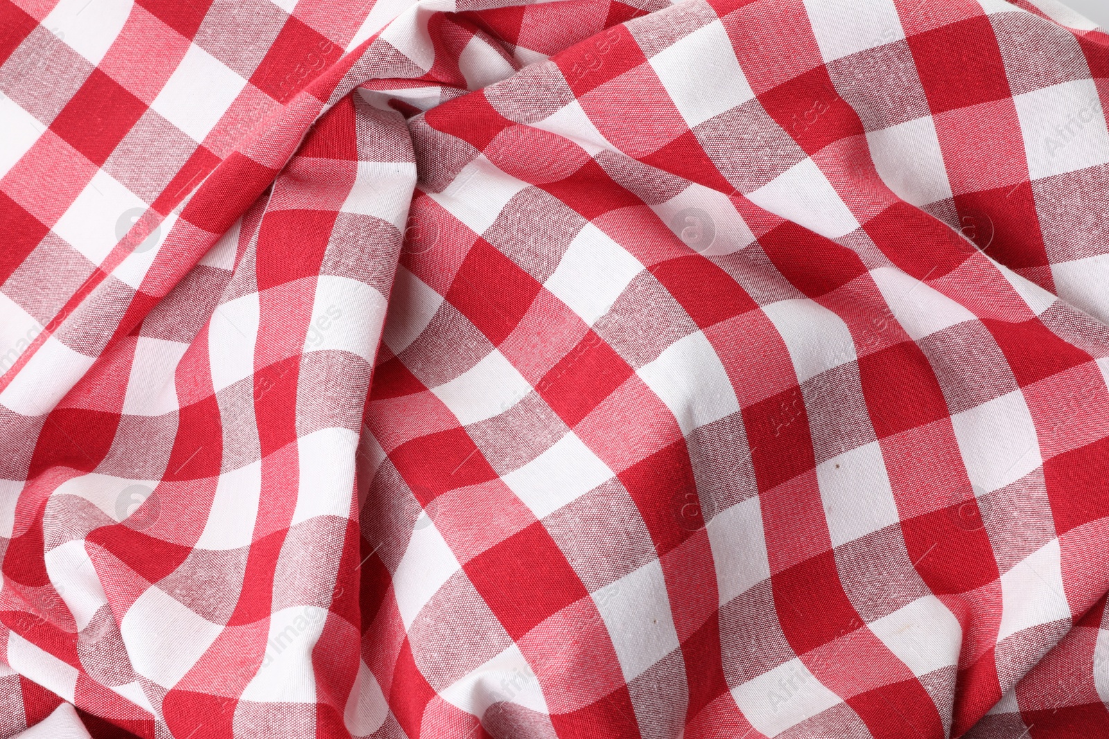 Photo of Crumpled checkered tablecloth as background, top view