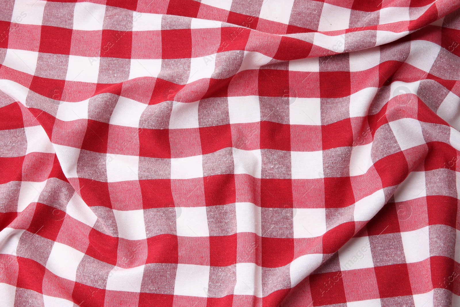 Photo of Crumpled checkered tablecloth as background, top view