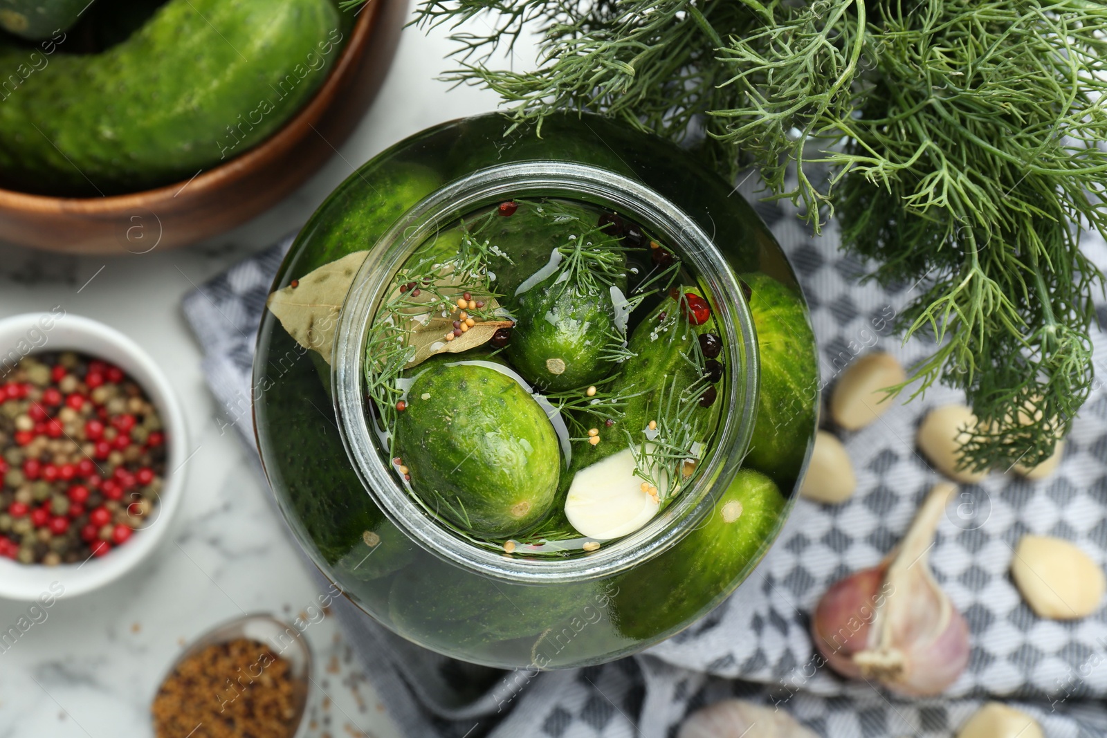 Photo of Making pickles. Fresh cucumbers and spices in jar on table, top view