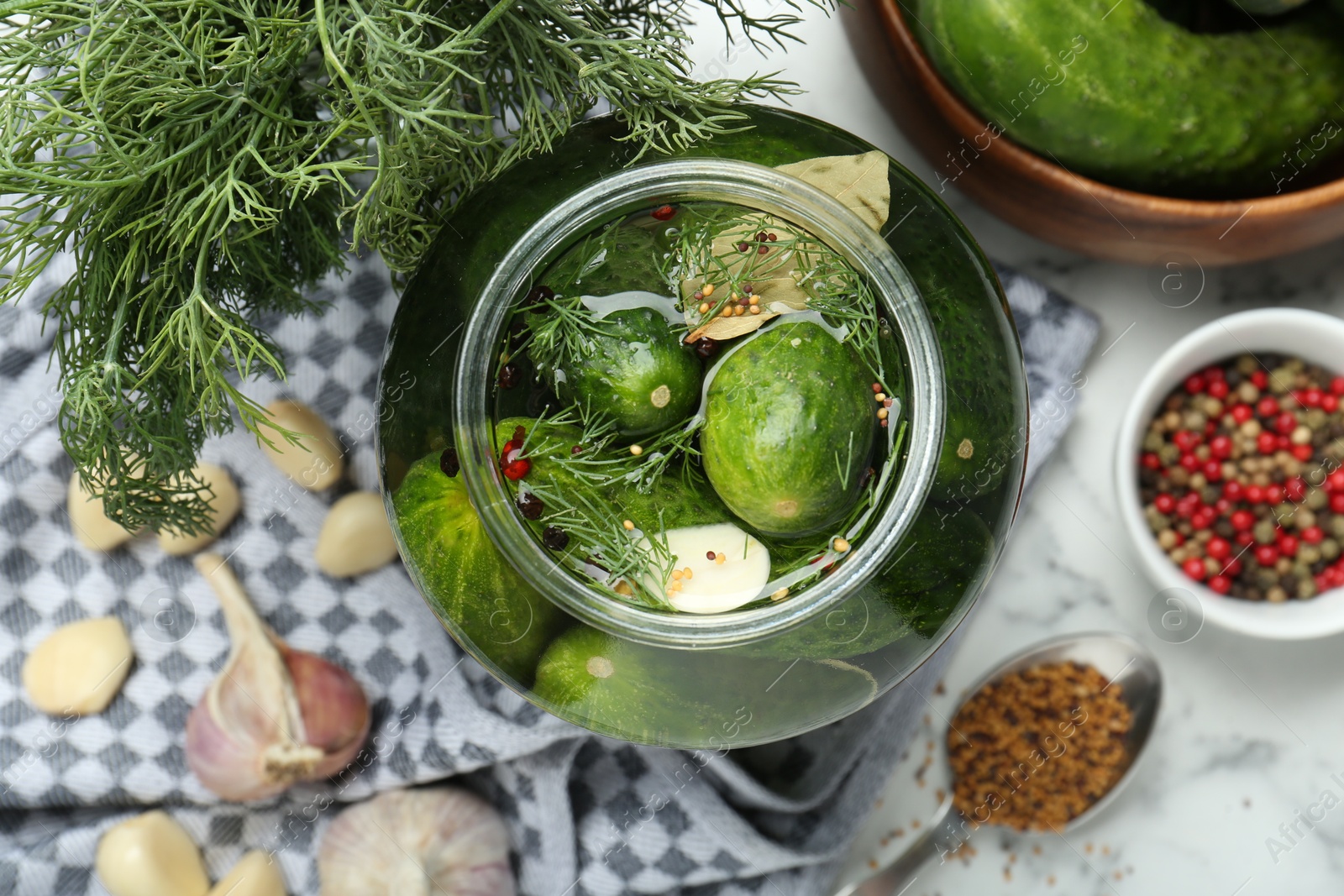 Photo of Making pickles. Fresh cucumbers and spices in jar on table, top view