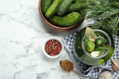 Photo of Making pickles. Fresh cucumbers and spices in jar on white marble table, top view. Space for text