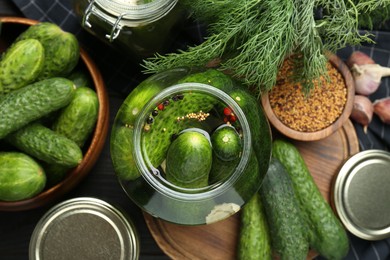 Photo of Making pickles. Fresh cucumbers and spices in jar on table, top view