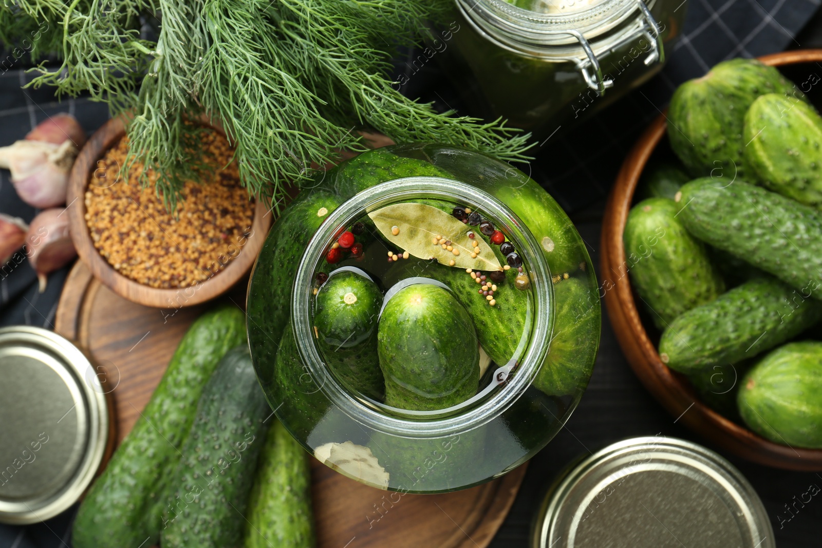 Photo of Making pickles. Fresh cucumbers and spices in jar on table, top view