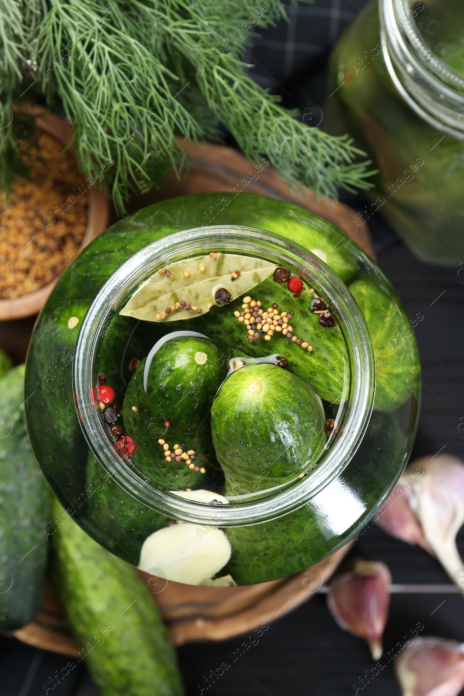 Photo of Making pickles. Fresh cucumbers and spices in jar on table, top view