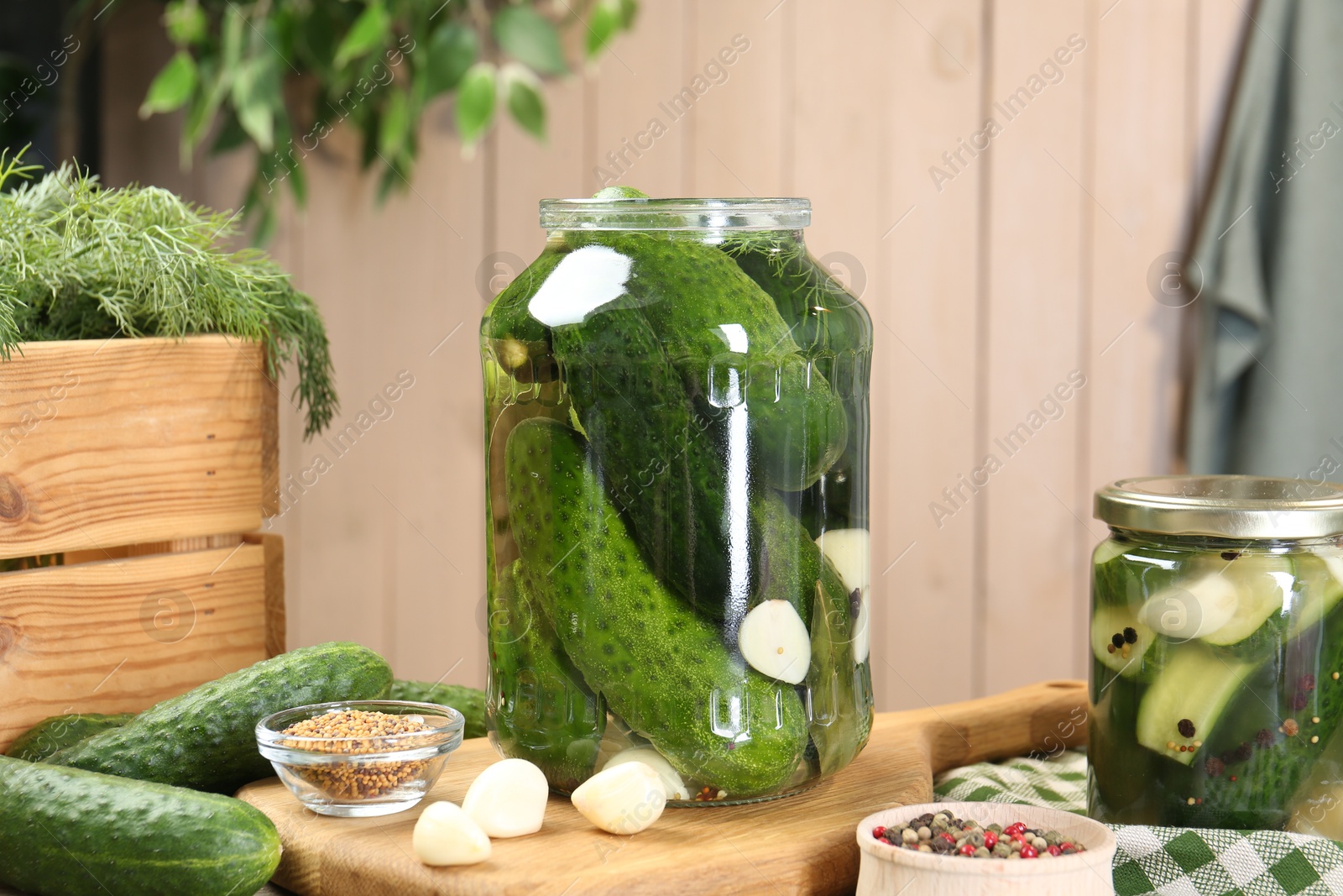 Photo of Making pickles. Fresh cucumbers and spices in jars on table