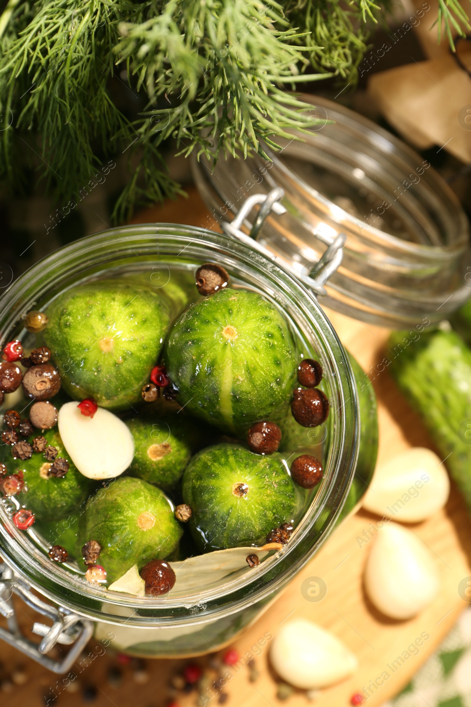 Photo of Making pickles. Fresh cucumbers and spices in jar on table, top view