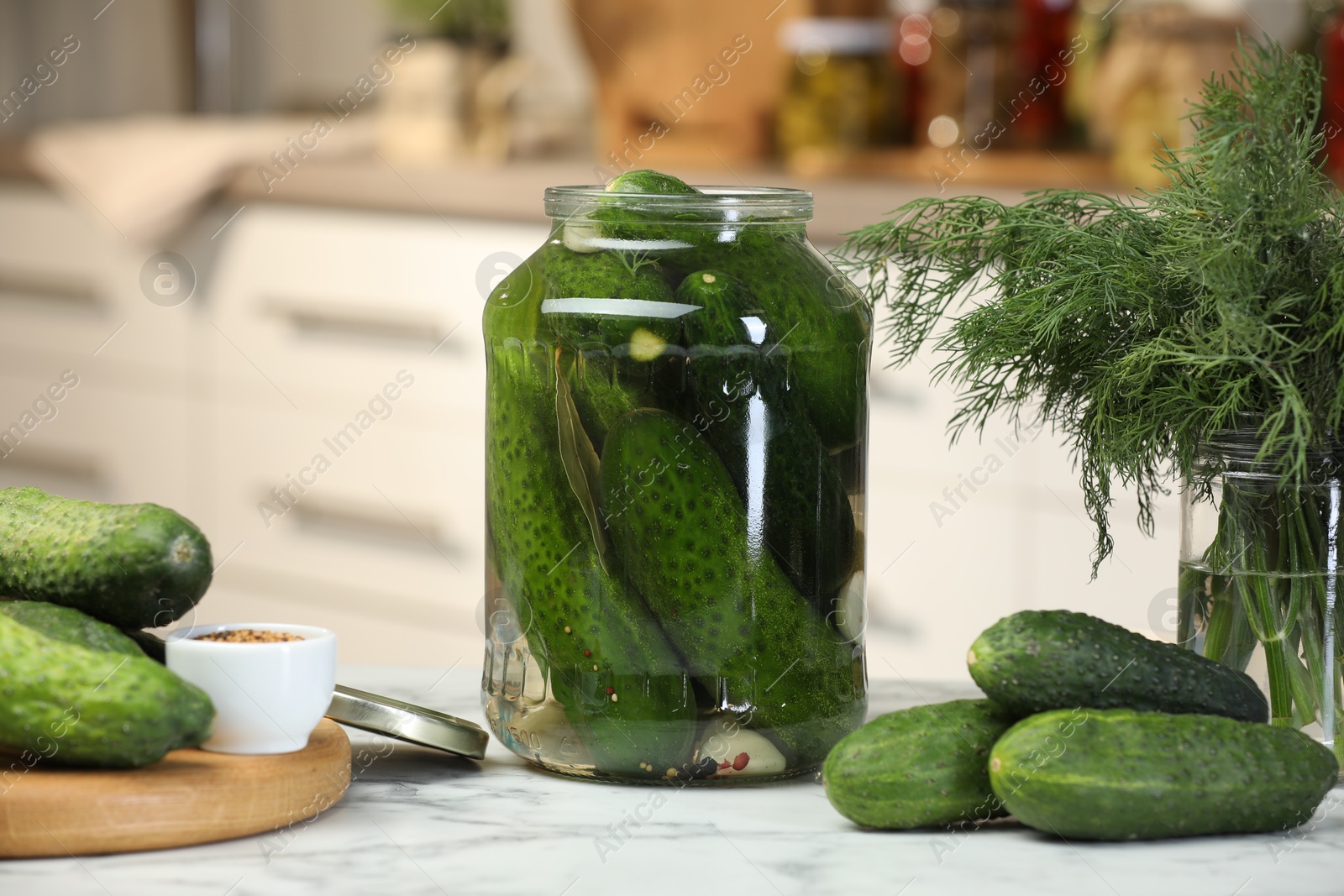 Photo of Making pickles. Fresh cucumbers and spices in jar on white marble table