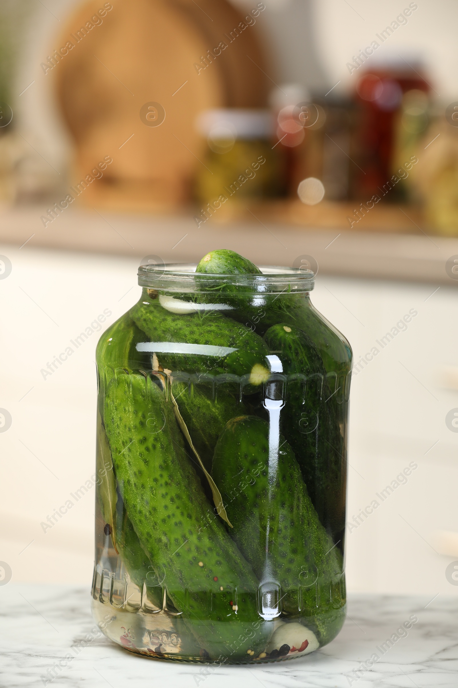 Photo of Making pickles. Fresh cucumbers and spices in jar on white marble table