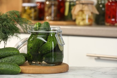 Photo of Making pickles. Fresh cucumbers and spices in jar on white marble table, space for text