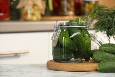 Photo of Making pickles. Fresh cucumbers and spices in jar on white marble table, space for text